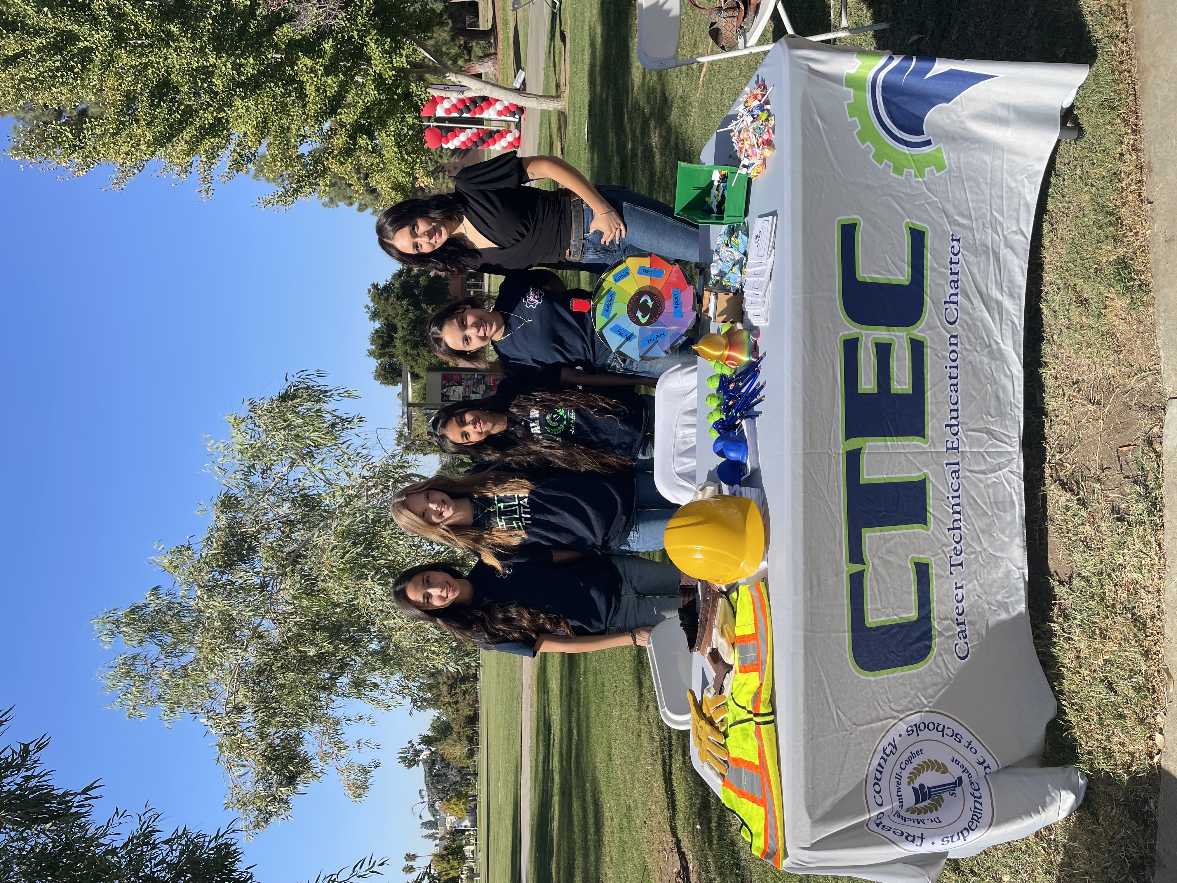 STEM for girls group posing near a table with construction gear